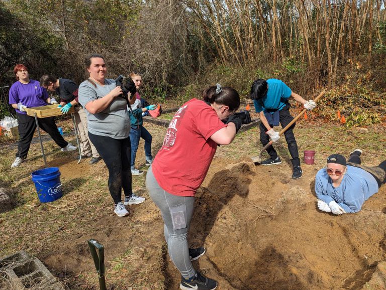 Crime Scene Technician students excavate during pig dig on Milton Campus Crime Scene Technician students examine and excavate carcass during annual pig dig at Pensacola Stat.