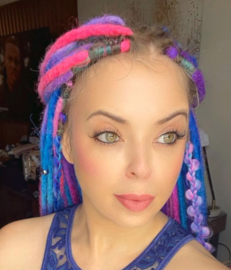 Pensacola State College Cosmetology alum at The Skin Games Beautiful cosmetology graduate with colorful dreadlocks at The Skin Games competition.