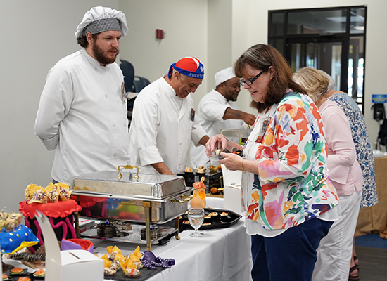 decorative image of Manger , Pensacola State supporters graze on grapes, grain at 2024 Garde Manger 2024-08-06 10:36:56