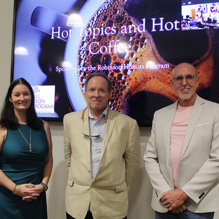 Engaged speakers discuss mental health topics at Pensacola State College seminar.