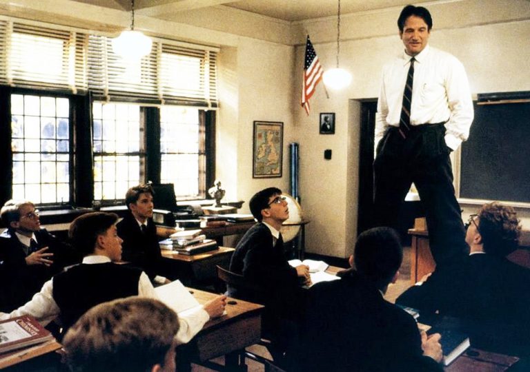 Inspiring students engaging with a teacher in a classroom setting at Pensacola State College. Classroom scene featuring students listening to an instructor in a higher education environment.