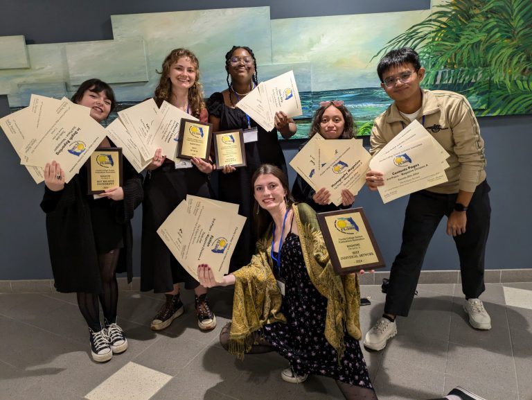 College students celebrating academic achievements with certificates and awards at an educational event. Students holding certificates and plaques at an academic awards ceremony.