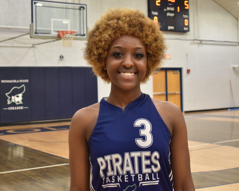 Katiya Casey, a talented student athlete at Pensacola State College, stands confidently in her baske.