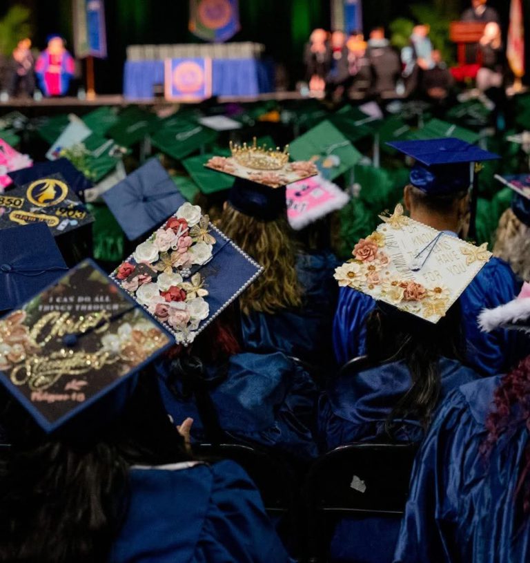 Graduation caps with floral decorations at Spring Graduation 2025 ceremony Colorful graduation caps with floral embellishments at Pensacola State College Spring Graduation 202.