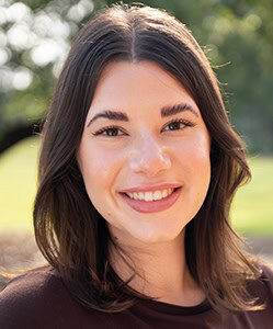 College recruiter engaging with prospective student outdoors at Pensacola State College.
