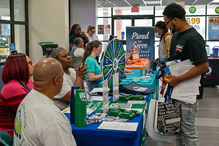 students interacting with vendors at a previous job fair