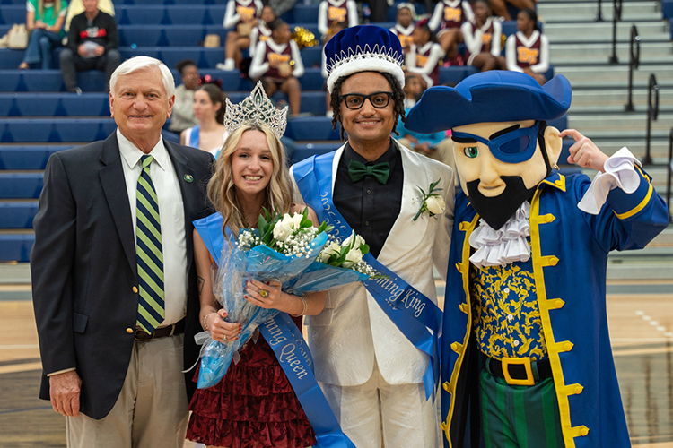 Dr. Meadows with 2026 Homecoming King, Queen, and Pete the Pirate.