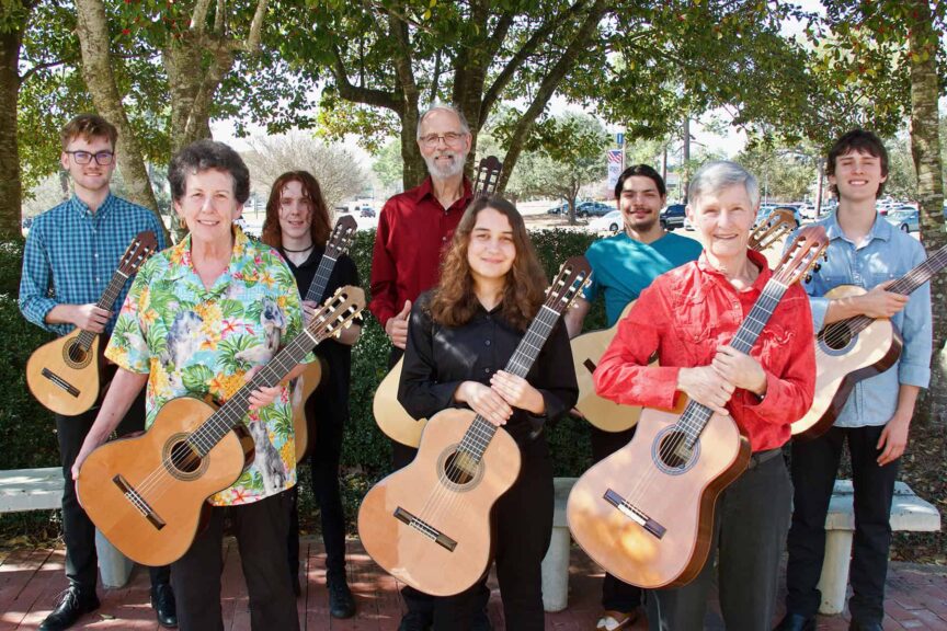 Ensemble of students performing guitar music at Pensacola State College Spring Recital event.