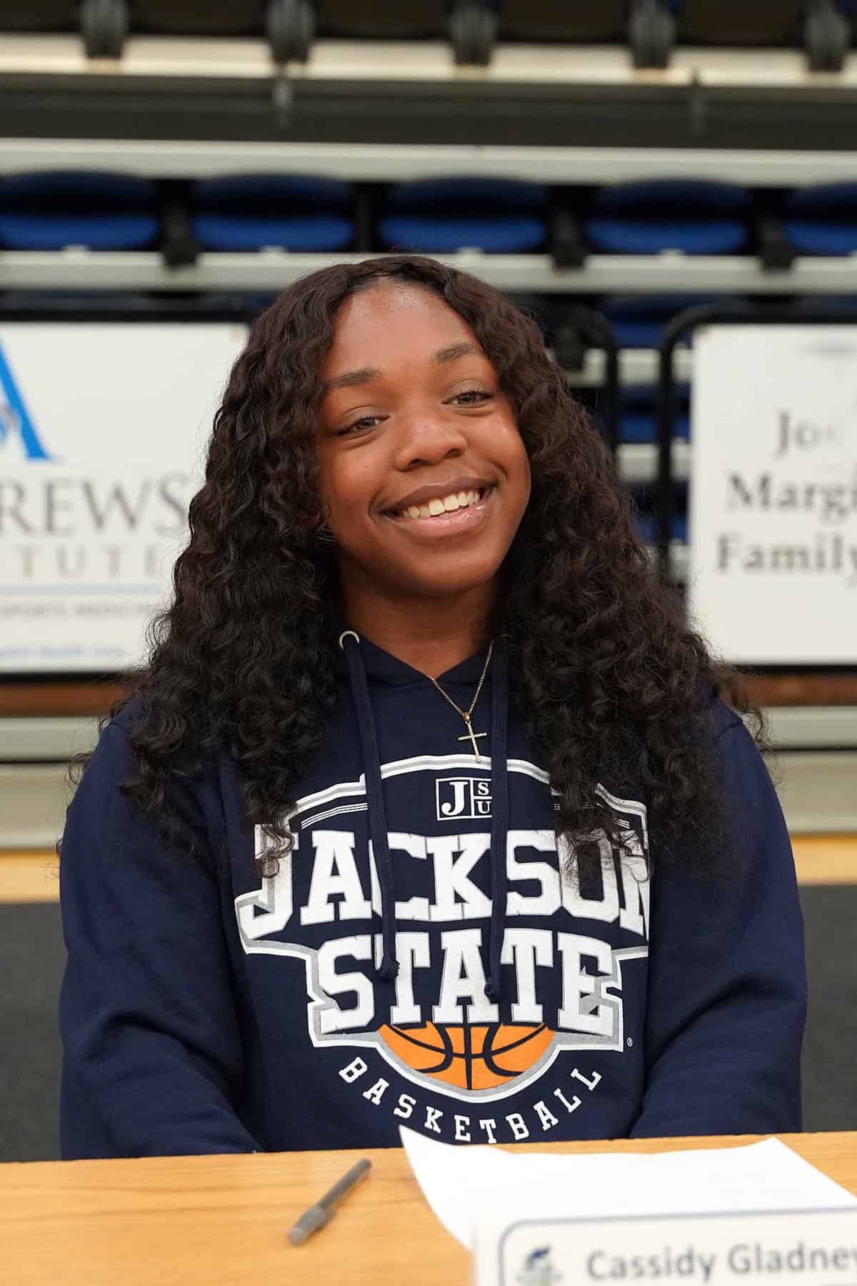 Image of student athlete on signing day.