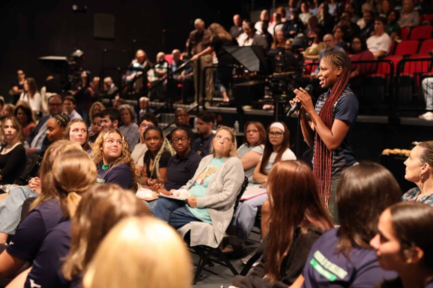 A student asks a question of Kelly during the meet-and-greet